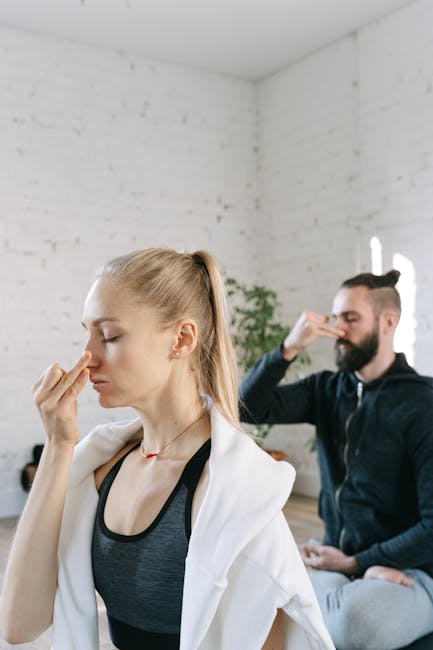 A serene woman practicing pranayama breathing by a window