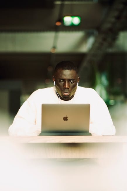 Focused man meditating in a modern light-filled office